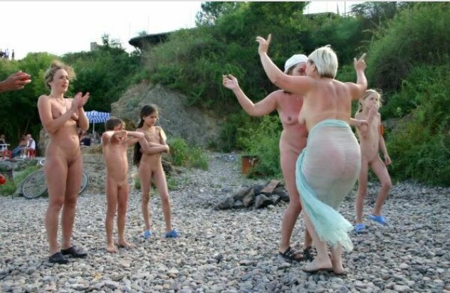 The company of nudists dances on a beach | NakedBody