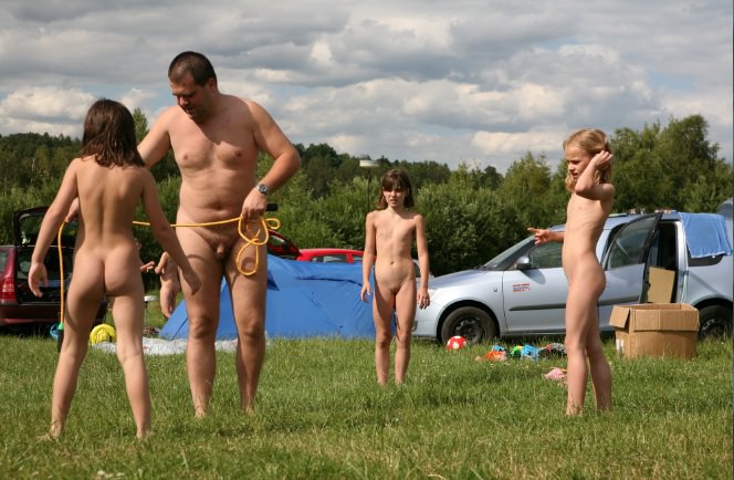 Family naturism - parents and children naturist bare outdoors |